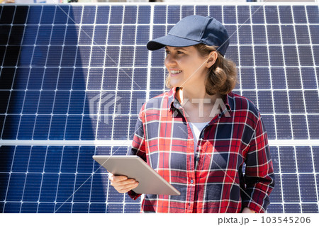 Woman with digital tablet on a background of solar power station 103545206