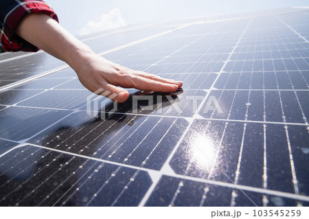 Hand touching a solar panel 103545259
