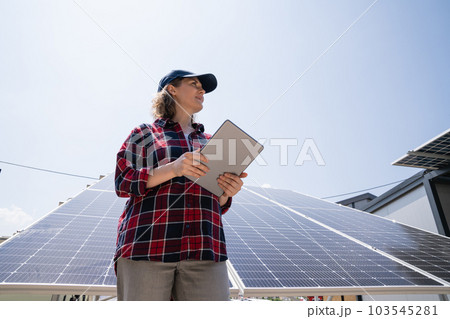 Woman with tablet on a background of mobile solar power station.. 103545281