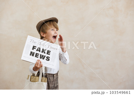 Newsboy shouting against grunge wall background. Boy selling fake news 103549661
