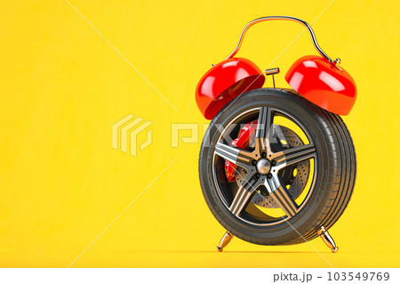 Time to change car tires or wheels. Car wheel  in the form of  alarm clock on gyellow background. 103549769