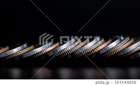 Close up of Coins are lined up in front on table. background is black. business and finance concept. Close up of Coins are lined up in front on table. background is black. business and finance concept. 103549856