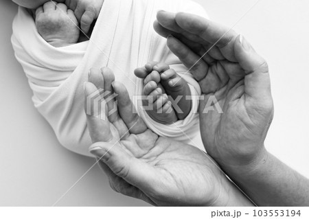 Black and white shade beautiful shape hands of mother, hold tiny newborn baby feet on white background with love, care, family safety and protection, child with premature birth concept or NICU care. 103553194