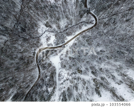 Top view of a road going through a snow covered winter nature 103554066