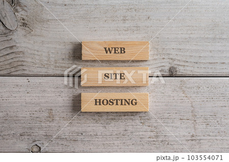 Three stacked wooden blocks with a Web site hosting sign on them 103554071