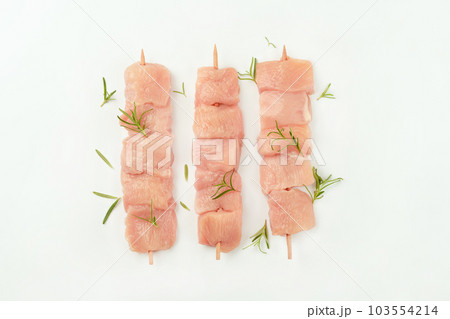 Chicken skewers.Chicken breast Fillets.Procurement for designers.Ogranic food,healthy eating.Skewers from raw chicken meat fillet for supermarket on white background.Food for retail. 103554214