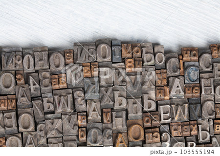 Antique vintage movable type alphabet set on white wooden deck 103555194