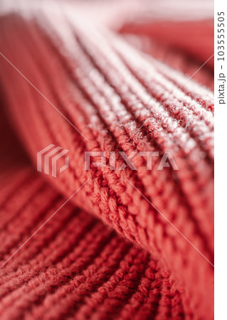 Knitted texture of a pink sweater or scarf close-up. 103555505
