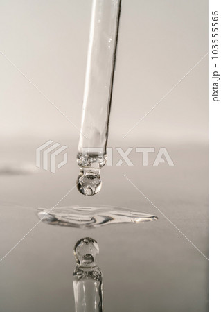 The texture of serum or oil with a pipette on a grey background. 103555566