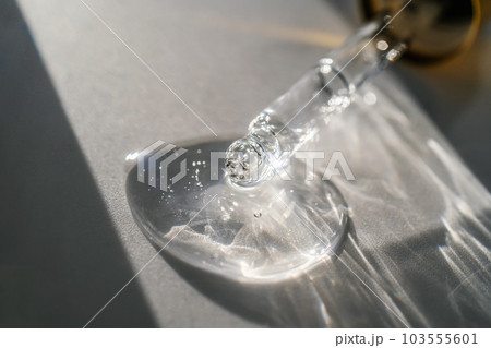 The texture of the serum or oil on an emerald background. 103555601