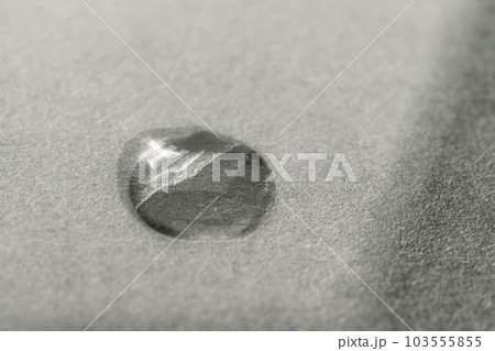 A drop of cosmetic product on a grey background. Texture. 103555855