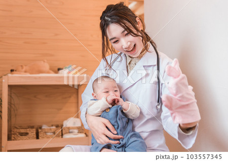 赤ちゃんを抱っこする産婦人科・新生児科・医者・医師・女医 103557345