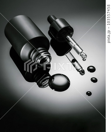 Black cosmetic bottle with dropper on black background. Black cosmetic bottle with dropper on black background. 103557458