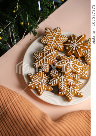 Ginger Christmas cookies on the on a delicate peach background. Ginger Christmas cookies on the on a delicate peach background. 103557575