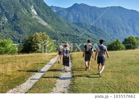 People hiking in the Alps, summer mountain landscape People hiking in the Alps, summer mountain landscape 103557662