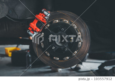 Checking car brake system for repair at car garage Checking car brake system for repair at car garage 103557912