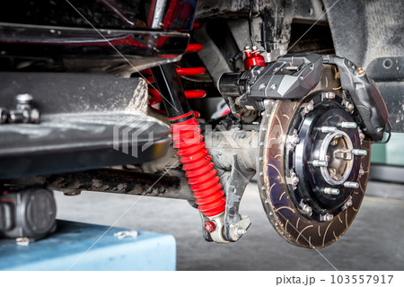 Checking car brake system for repair at car garage Checking car brake system for repair at car garage 103557917