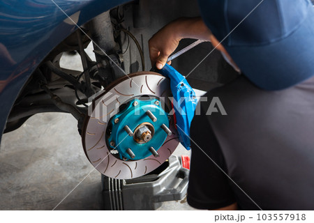 Checking car brake system for repair at car garage Checking car brake system for repair at car garage 103557918