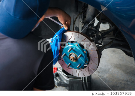Checking car brake system for repair at car garage Checking car brake system for repair at car garage 103557919