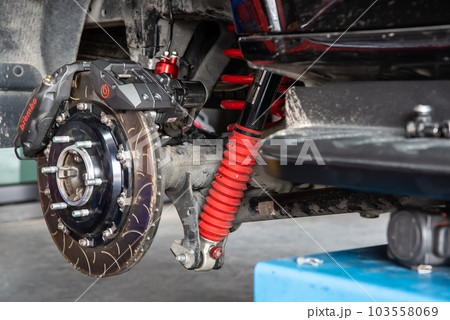 Checking car brake system for repair at car garage 103558069