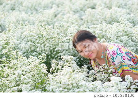 Woman (LGBTQ) posing at flower park garden field 103558130