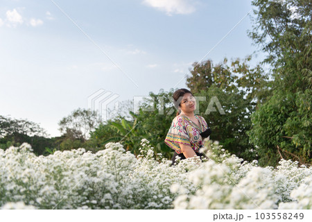 Woman (LGBTQ) posing at flower park garden field 103558249