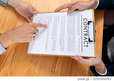 Businessman or client carefully reviewing contract document. Entity 103560093
