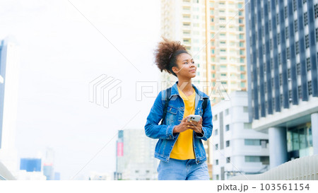 Black young woman, using smart phone and smile with walking in the city outdoor Black young woman, using smart phone and smile with walking in the city outdoor 103561154