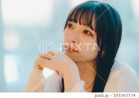 都会の夕焼けに佇む若い女性 都会の夕焼けに佇む若い女性 103563574