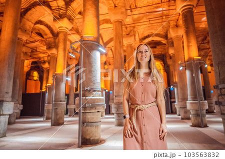 Woman tourist enjoying Beautiful cistern in Istanbul. Cistern - underground water reservoir build in 6th century, Istanbul, Turkey, Turkiye Woman tourist enjoying Beautiful cistern in Istanbul. Cistern - underground water reservoir build in 6th century, Istanbul, Turkey, Turkiye 103563832
