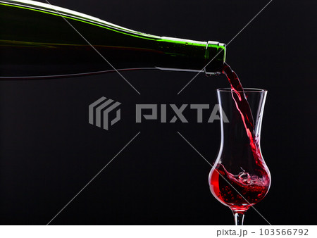 bottle and glass with alcoholic drink 103566792