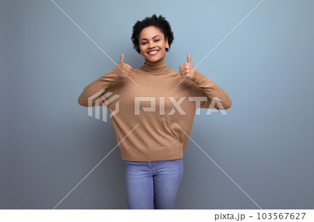 young optimistic latin woman with curly hair smiling on background with copy space young optimistic latin woman with curly hair smiling on background with copy space 103567627
