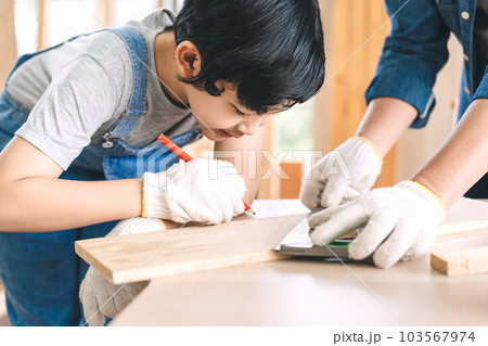 Southeast asian family father and son living together homeschooling 103567974