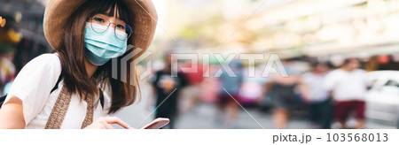 Young adult asian woman travel wear face mask for corona virus or covid 19 103568013