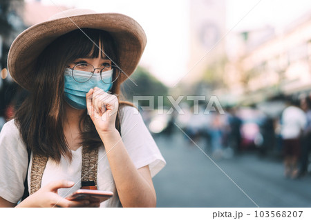 Young adult tourist asian traveller women wear protective face mask and eyeglasses for virus corona or covid 19. Young adult tourist asian traveller women wear protective face mask and eyeglasses for virus corona or covid 19. 103568207