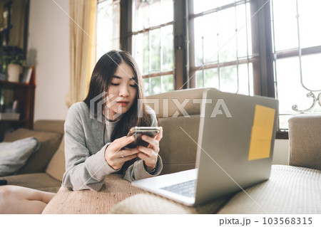 Young adult asian woman using mobile phone for trade crypto currency financial at home. Young adult asian woman using mobile phone for trade crypto currency financial at home. 103568315