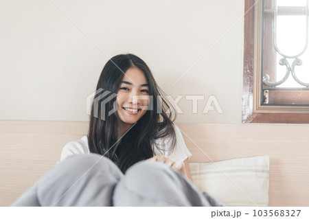Portrait young adult asian pretty woman after wake up in morning with sunlight Portrait young adult asian pretty woman after wake up in morning with sunlight 103568327