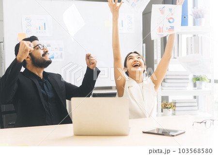 Southeast asian business people raised hand with throw document paper for eureka happy in office 103568580