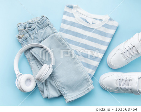 Child's t-shirt, shoes and headphones on blue backgrund Child's t-shirt, shoes and headphones on blue backgrund 103568764