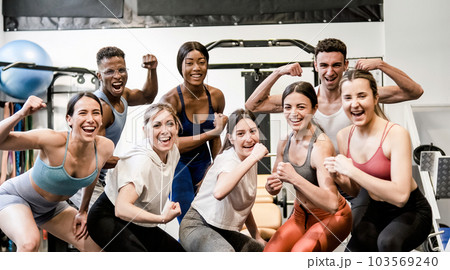 Happy diverse sportspeople having fun in fitness club together 103569240