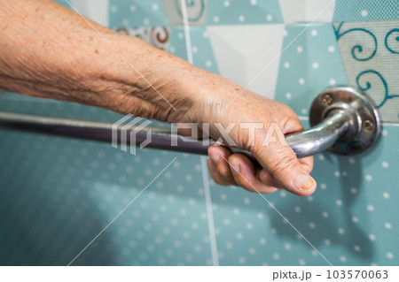 Asian senior woman patient use toilet bathroom handle security in nursing hospital, healthy strong medical concept. 103570063