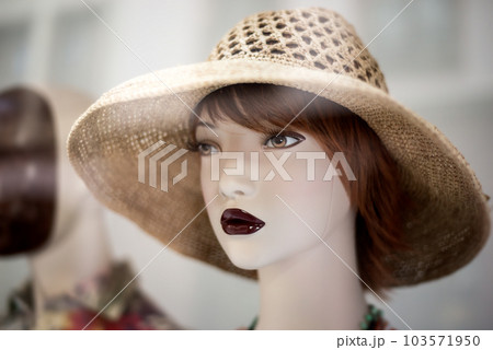 Closeup of summer hat on the head of mannequin in a fashion store showroom Closeup of summer hat on the head of mannequin in a fashion store showroom 103571950