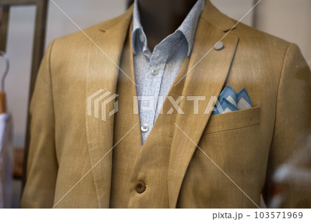 Closeup of brown wedding suit on mannequin in wedding store showroom Closeup of brown wedding suit on mannequin in wedding store showroom 103571969