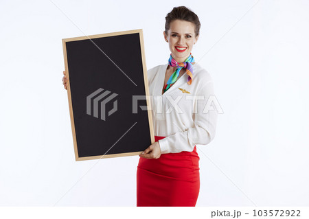 smiling elegant flight attendant woman on showing blank board smiling elegant flight attendant woman on showing blank board 103572922