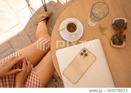Wood office desk table with laptop computer, cup of coffee and smartphone. Top view with copy space, flat lay. Working from home in the morning concept. 103576073