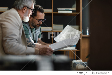 Young architect consulting project with senior colleague. 103580887