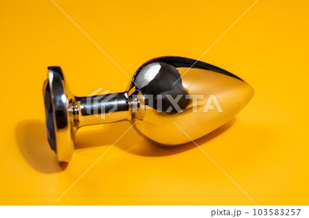 doppeldildo paar Steel anal plug on an orange background. Sex... - Stock Photo [103583257]