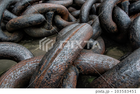 Large partially rusted eyes of huge ship chain. 103583451