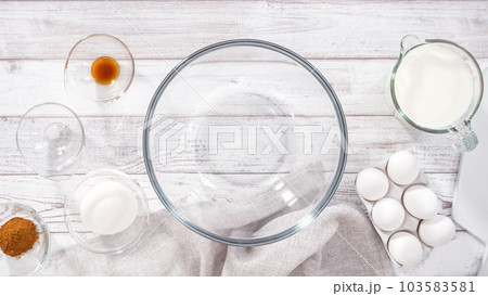 Step by step. Mixing ingredients in a large glass mixing bowl to prepare French toast. Step by step. Mixing ingredients in a large glass mixing bowl to prepare French toast. 103583581