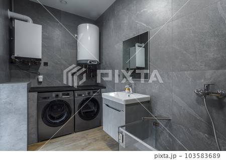 Modern furnished bathroom dark grey interior design with granite tiles Modern furnished bathroom dark grey interior design with granite tiles 103583689